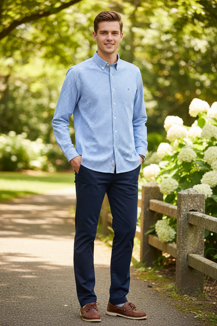 Folded blue and white checkered shirt with brand logo on a light gray background