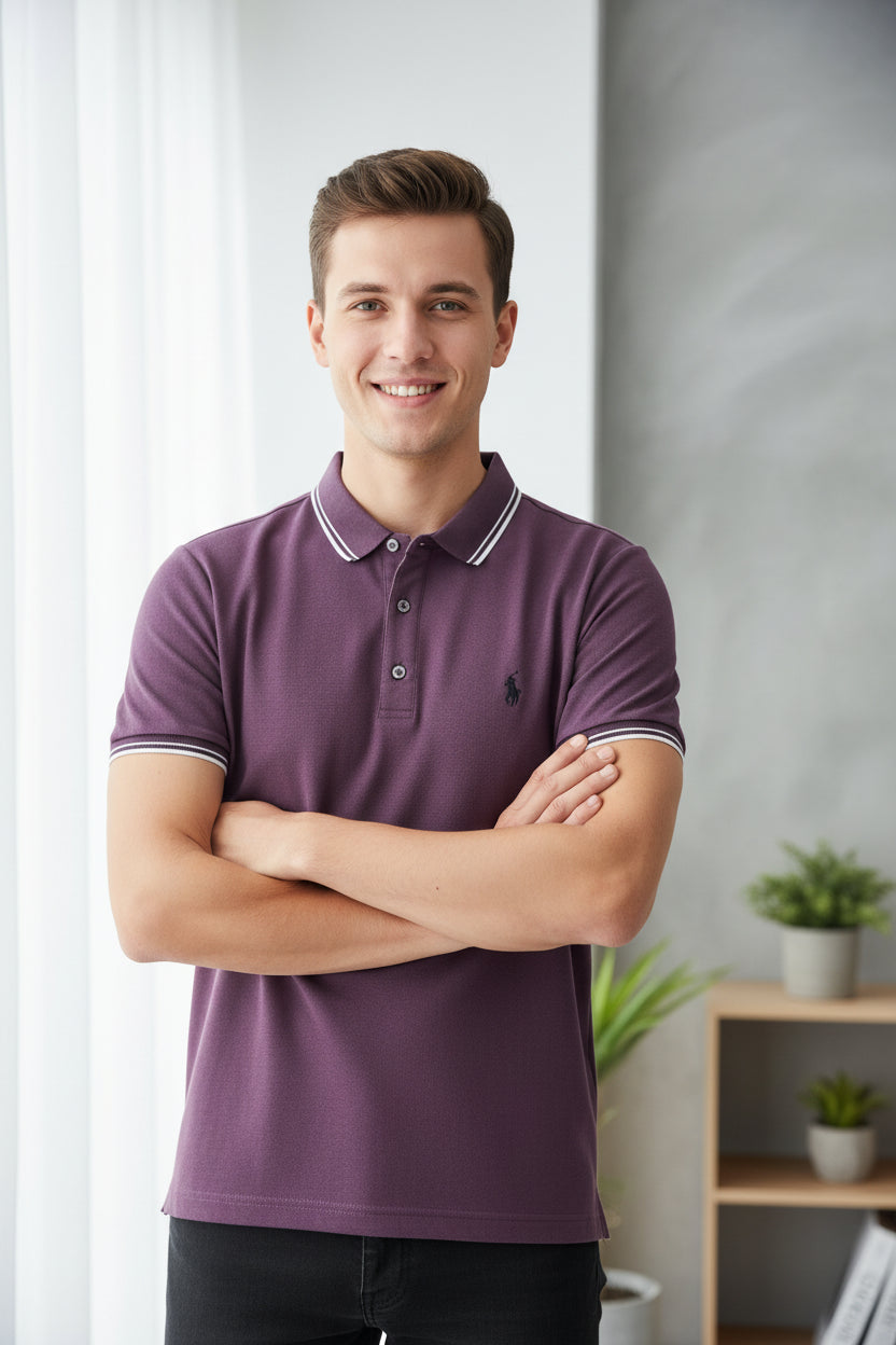 Purple polo shirt with white trim on a rack with other shirts in the background