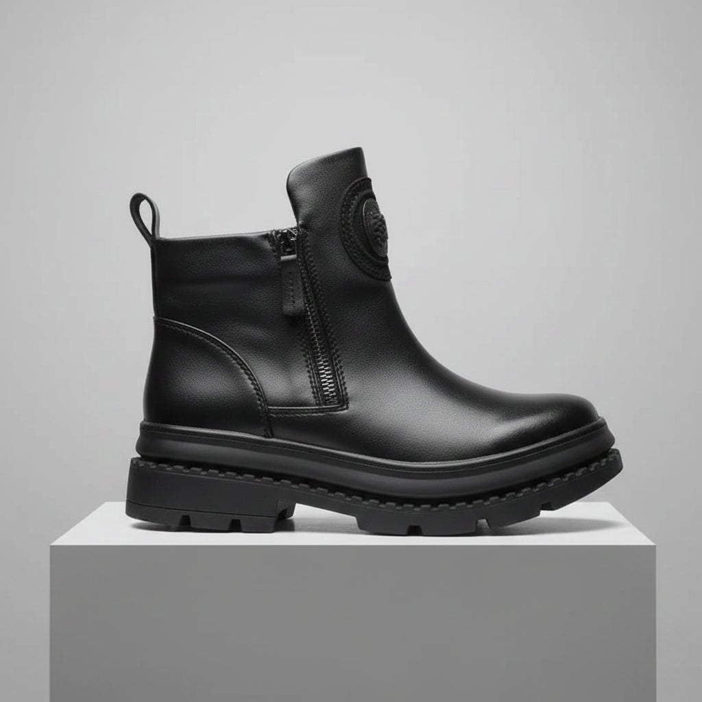 Black leather boot on a reflective surface with a black background