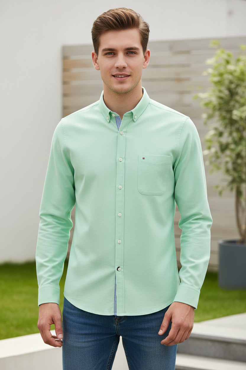 Light green shirt with collar and buttons on a white background