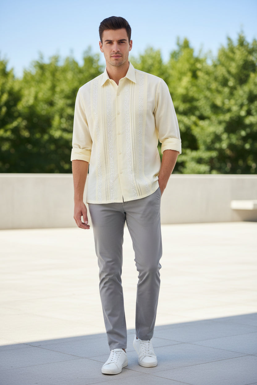 Light yellow long-sleeve shirt with intricate patterns on a white background
