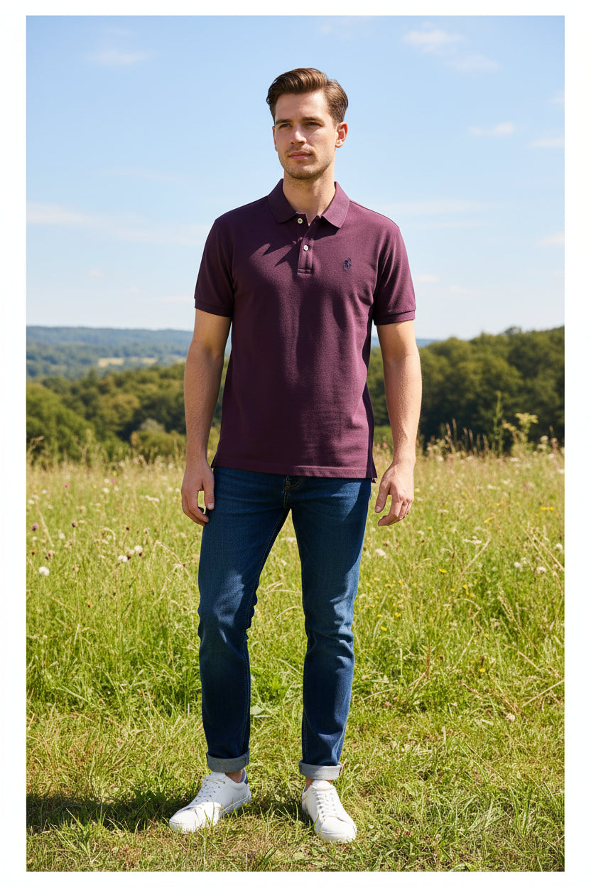 Purple polo shirt on a hanger with visible brand logo, against a blurred clothing rack background.