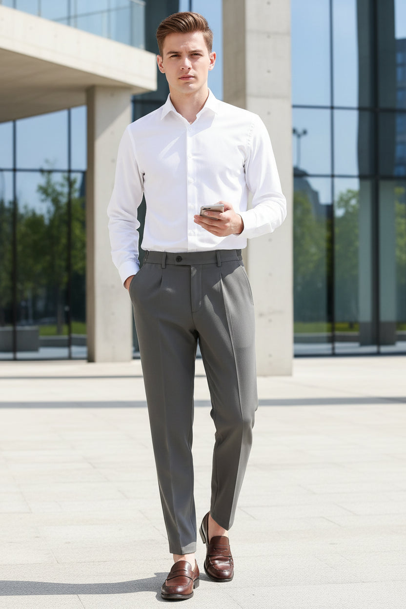 Person wearing gray dress pants and brown shoes in an indoor setting.