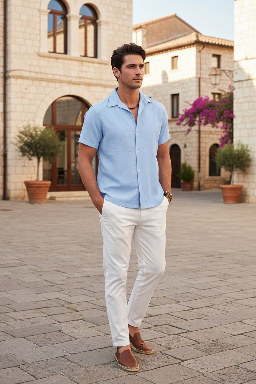 Man wearing a light blue short-sleeve shirt on a white background