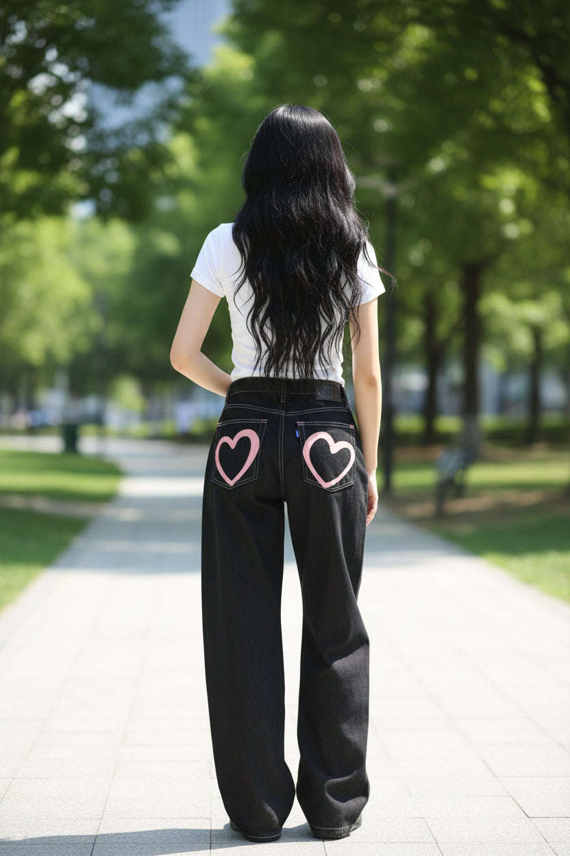 Person wearing black jeans with a heart design on a white background