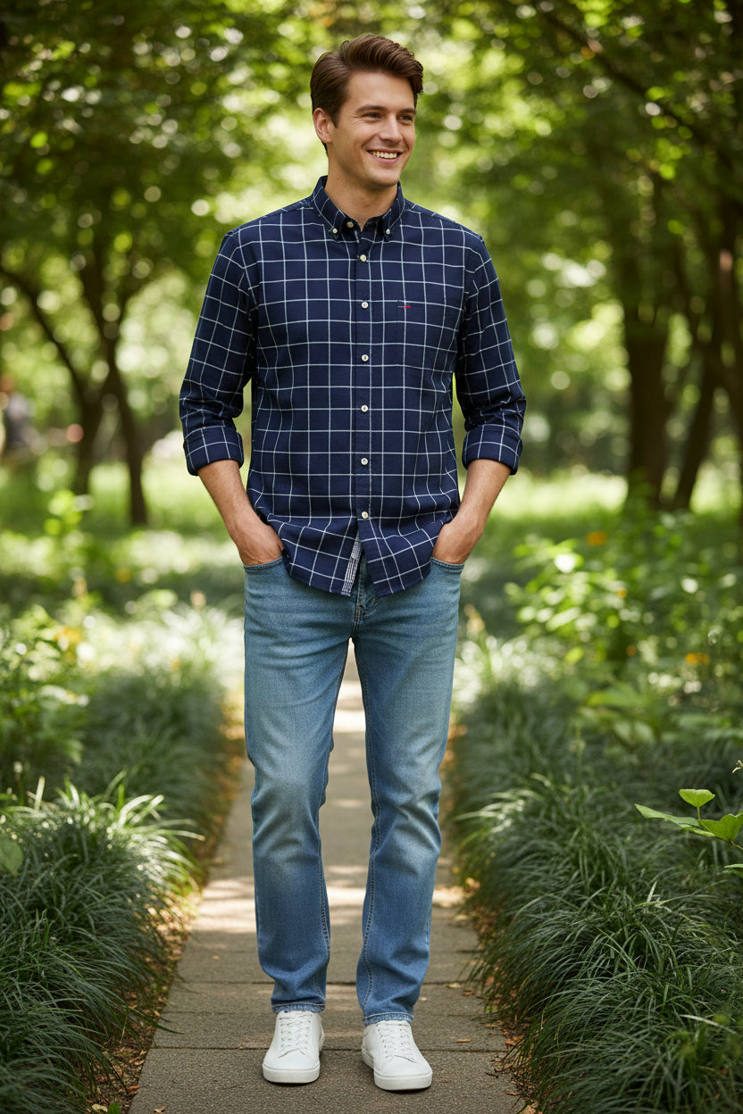 Folded navy blue checkered shirt with brand logo on a light gray background