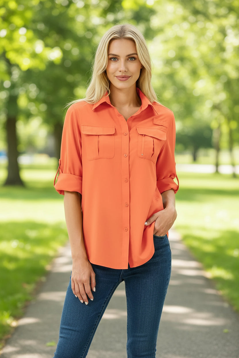 Woman wearing an orange button-up shirt with rolled-up sleeves on a white background