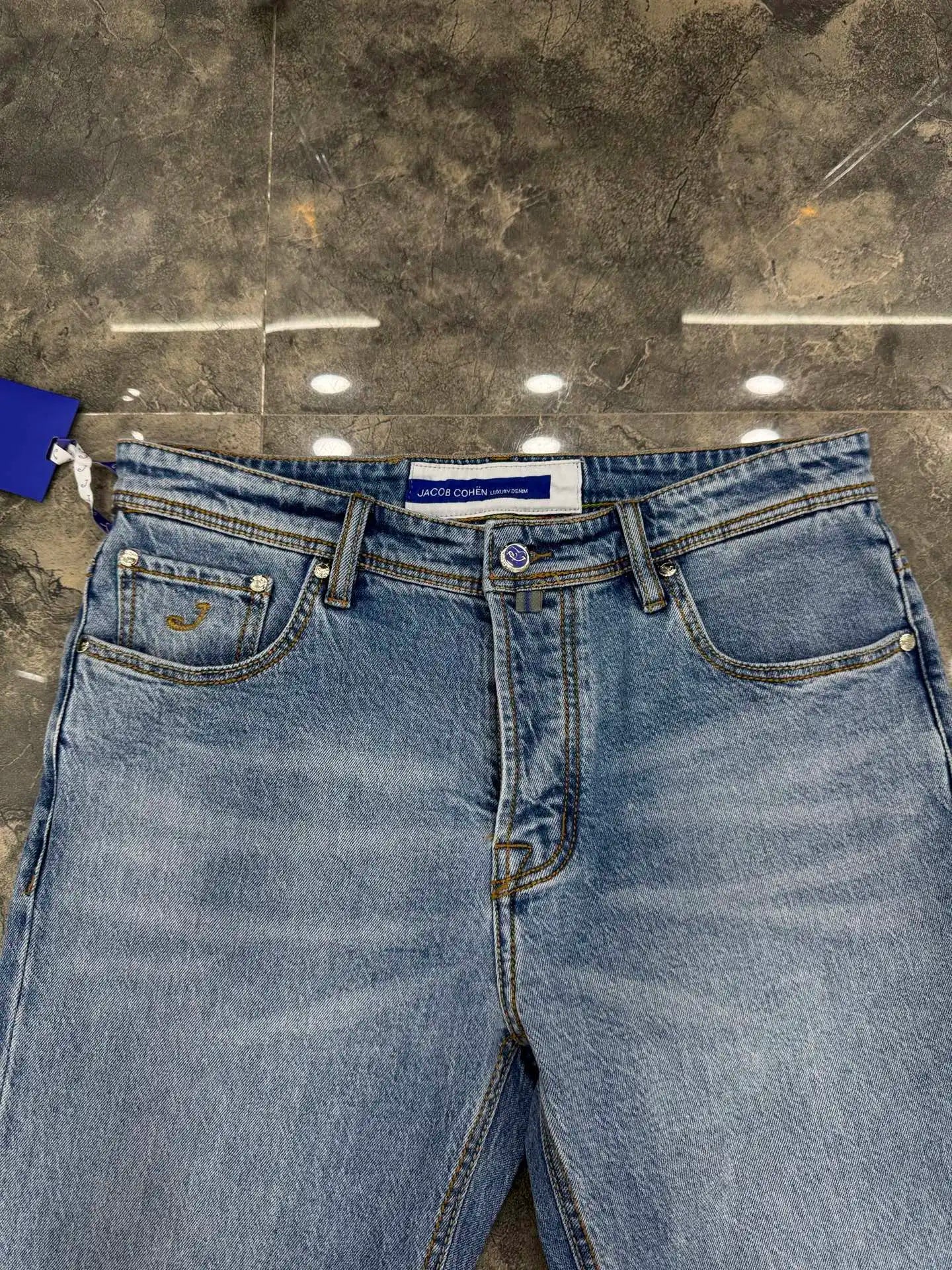 Blue jeans on a gray concrete floor