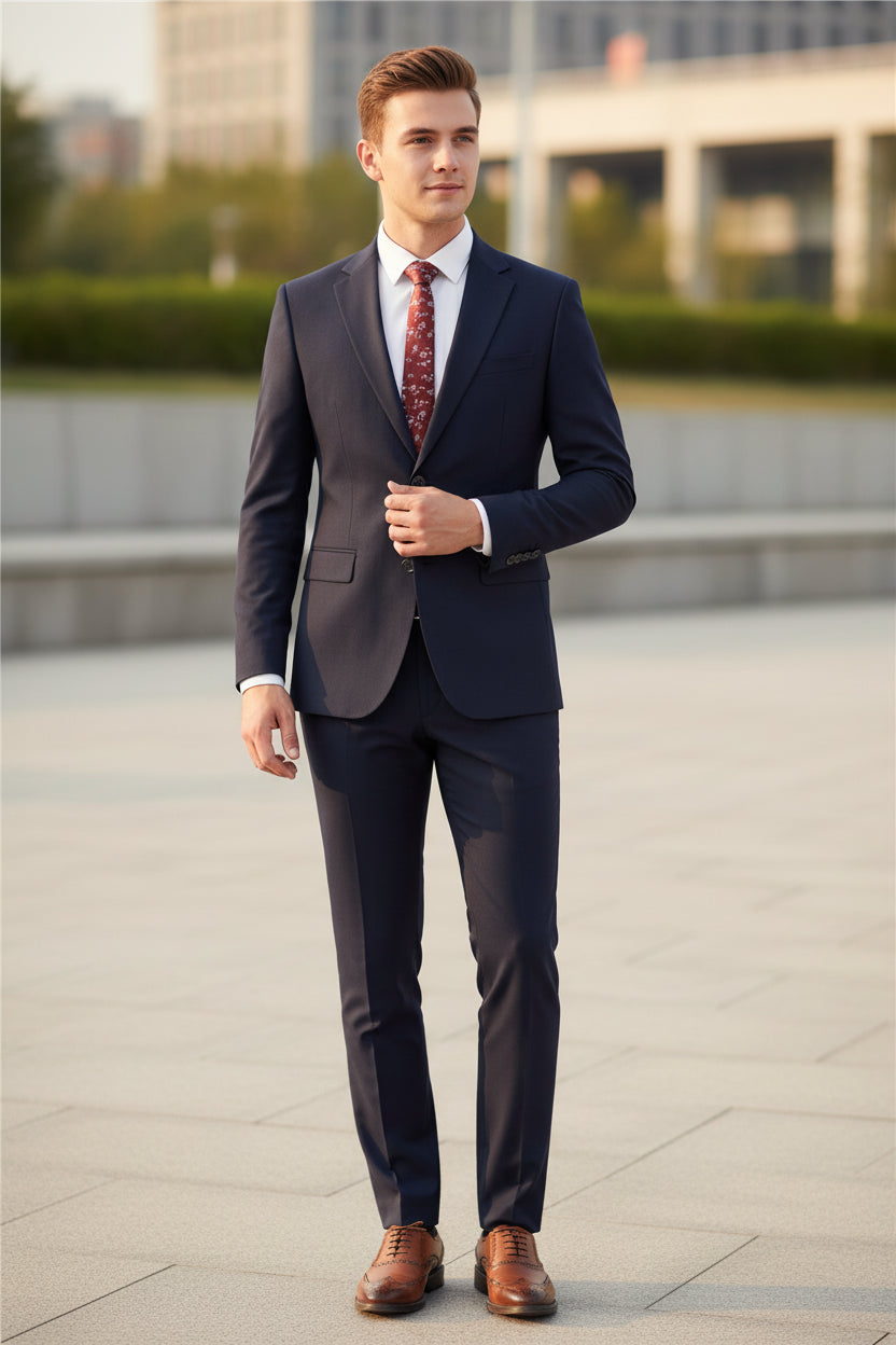Black suit with a red patterned tie on a mannequin, paired with brown shoes on a white background.