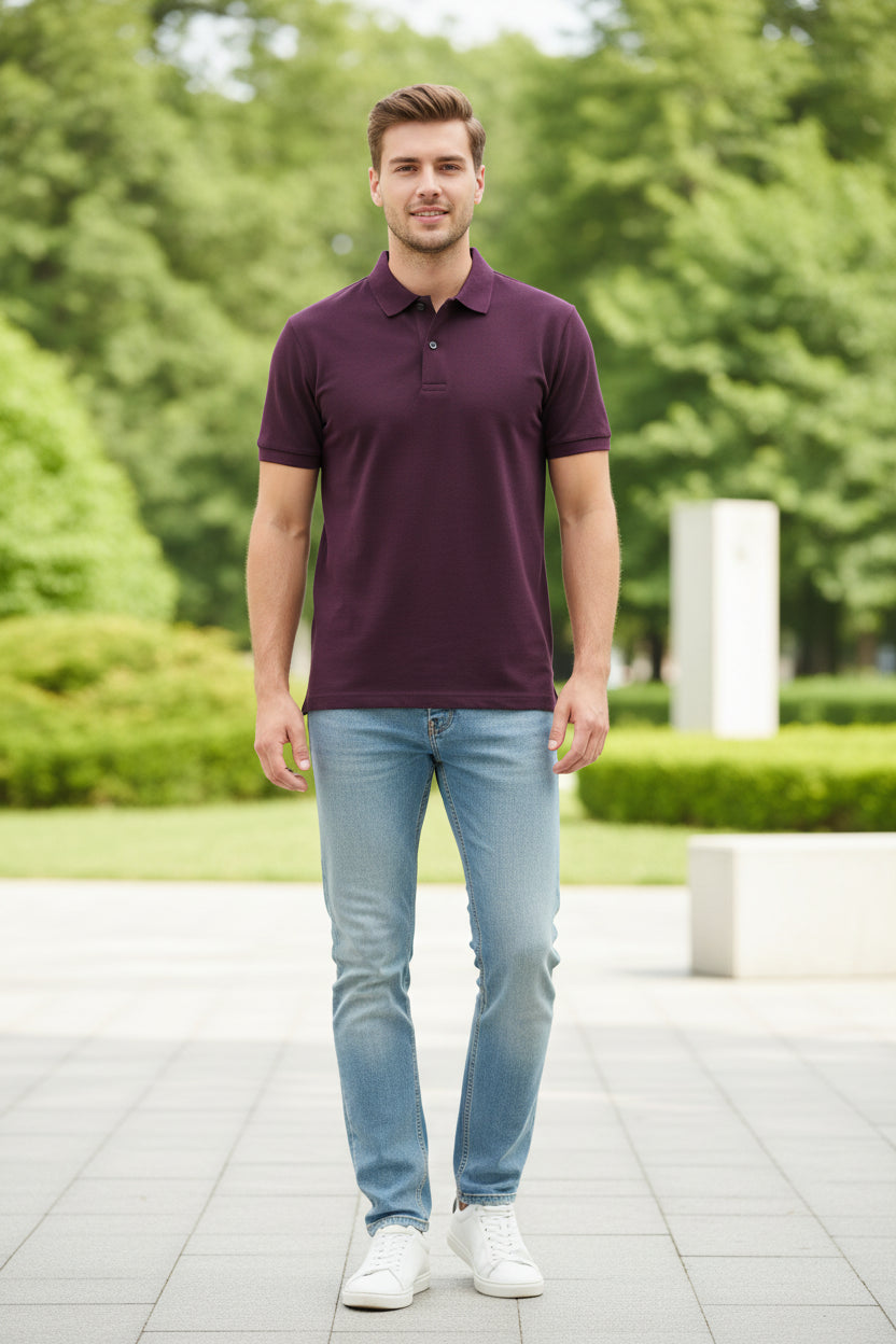 Purple polo shirt on a hanger with a hand touching the fabric