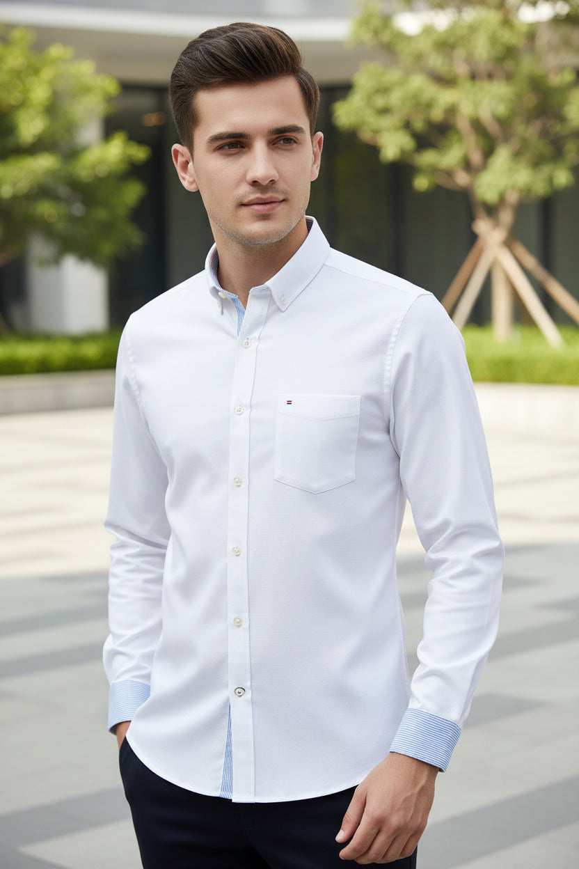 White dress shirt with blue collar and cuff on a light gray background