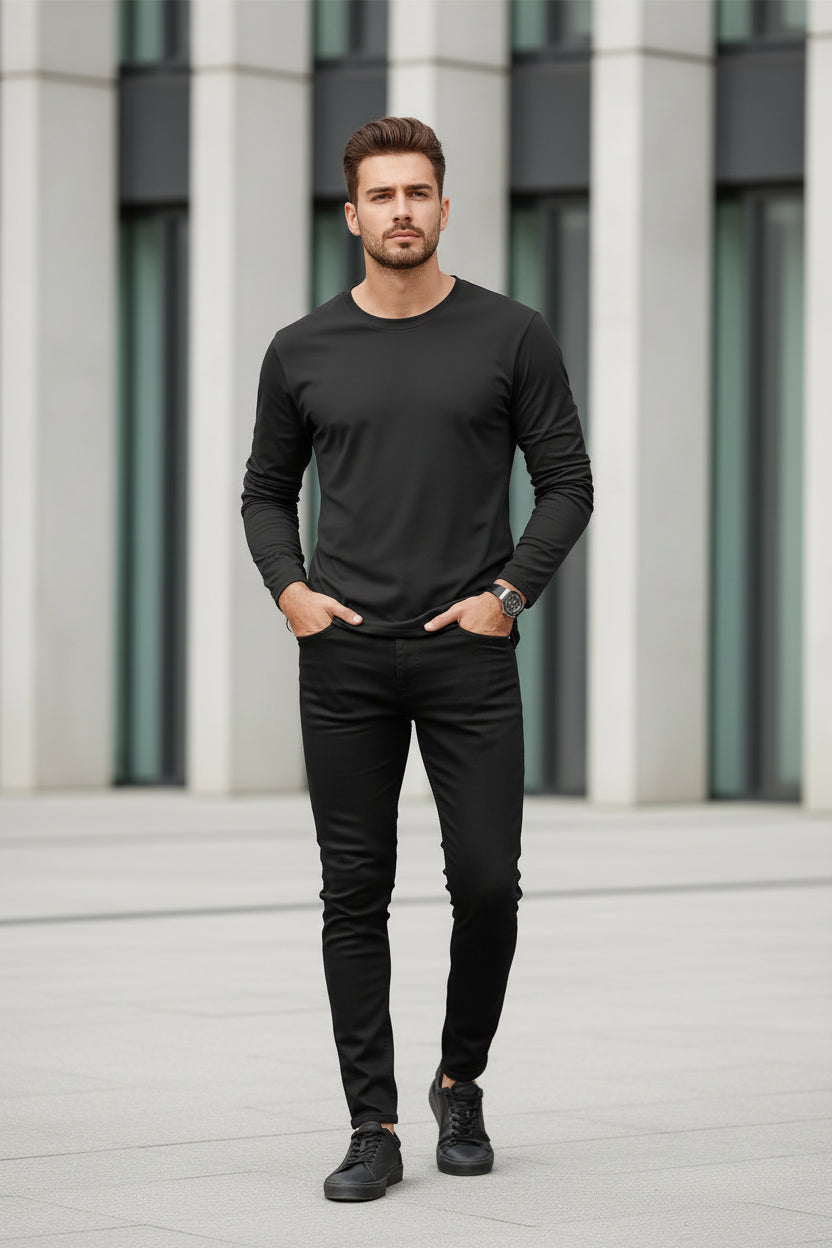 Man wearing a black long-sleeve shirt with a blurred background
