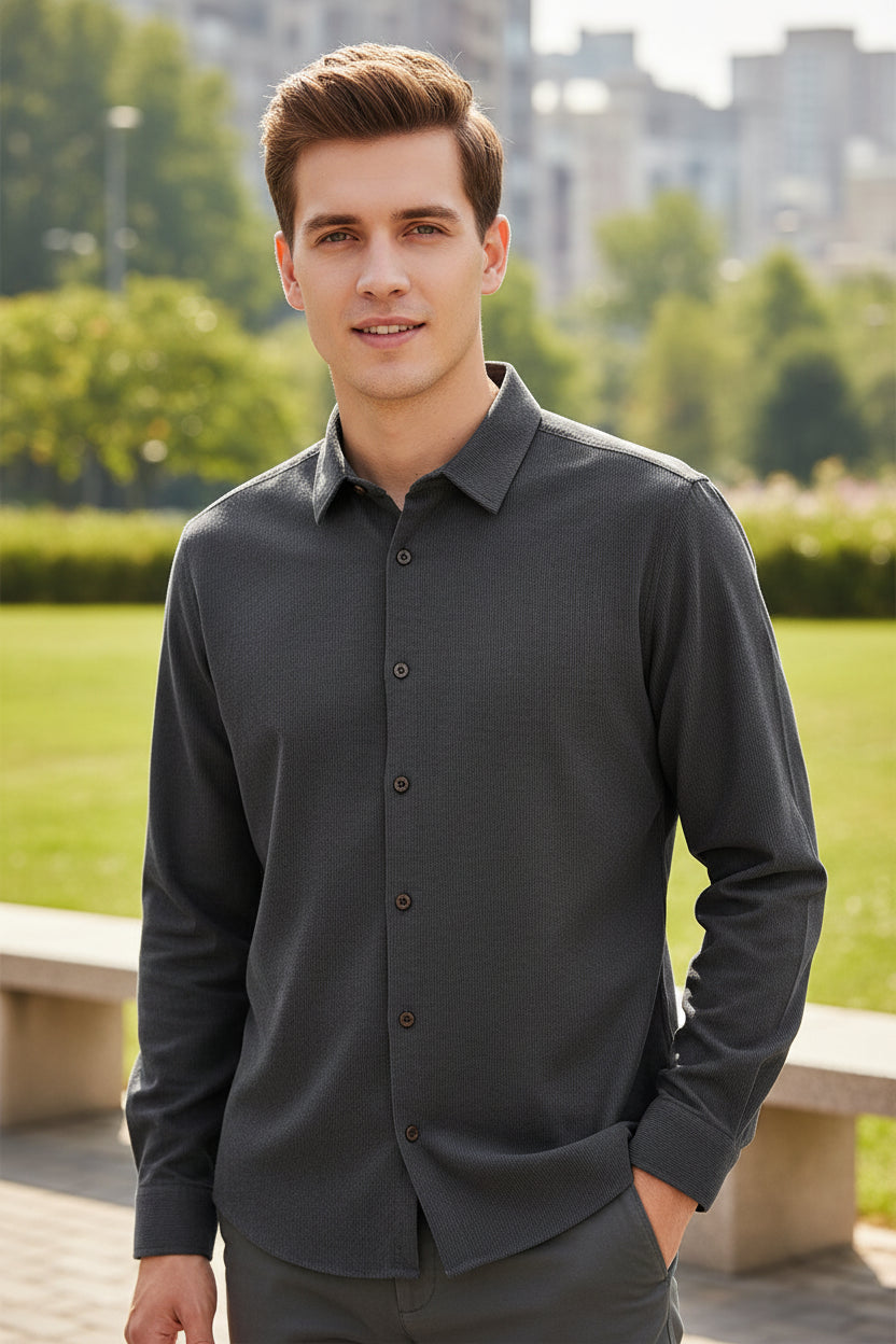 Folded gray shirt with brown buttons on a white background