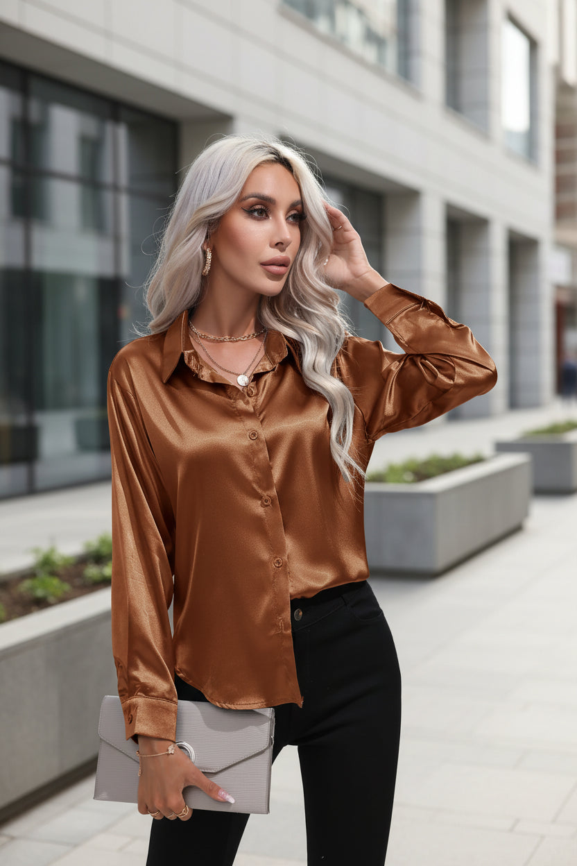 Woman wearing a brown satin shirt with a white background