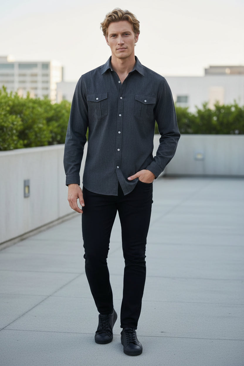 Man standing on a rooftop with a cityscape in the background