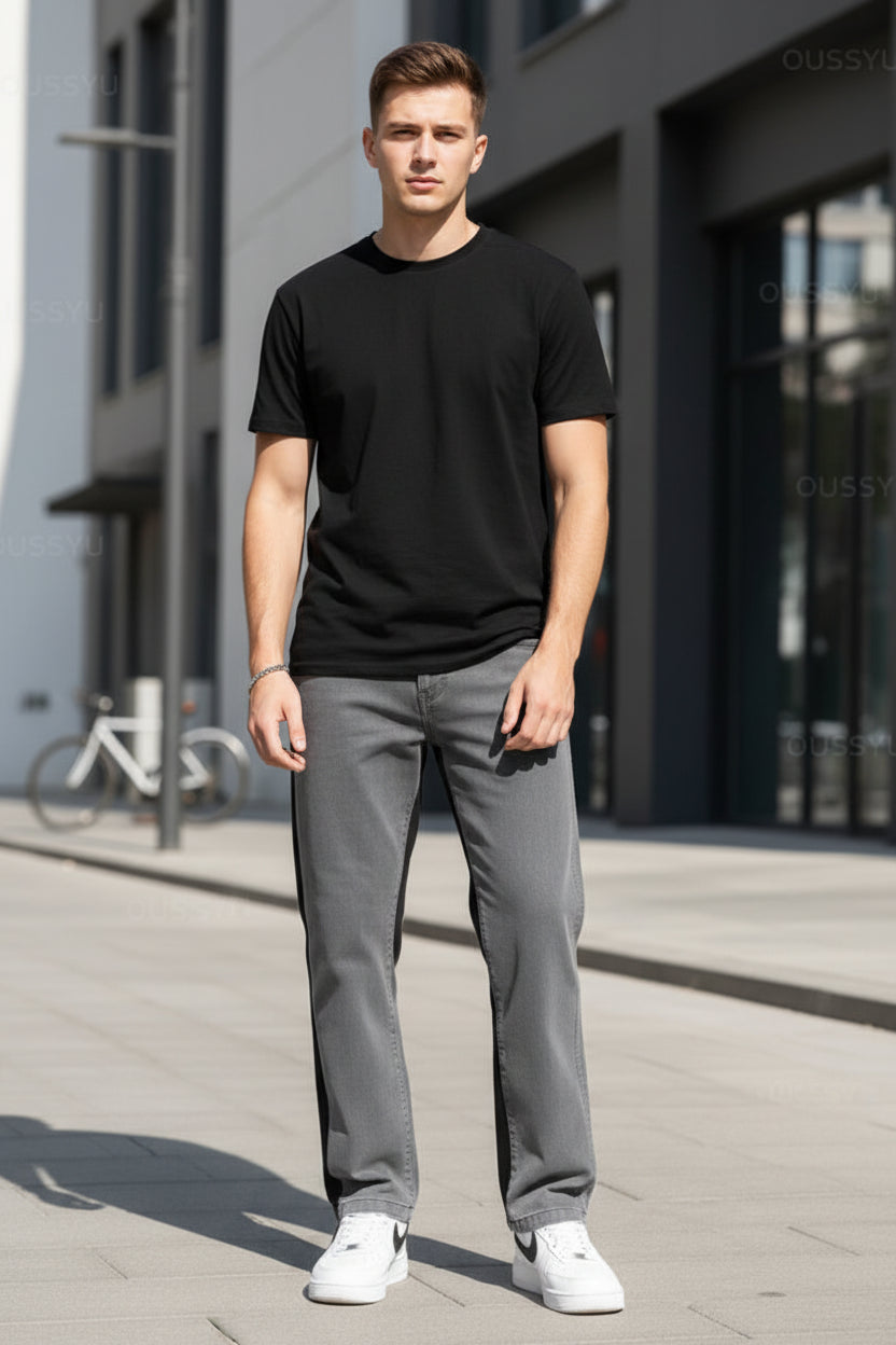 Person wearing gray pants and white shoes against a gray background