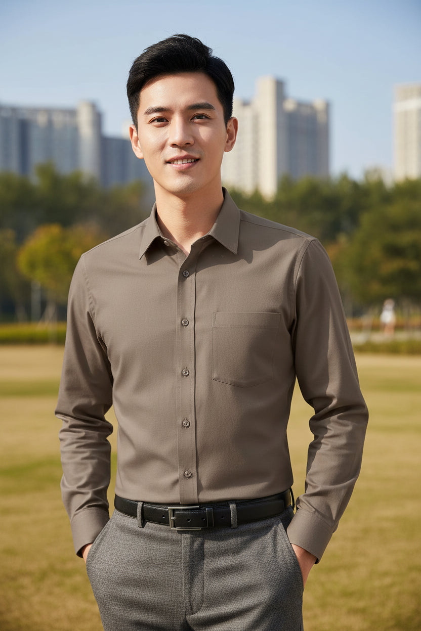 Folded brown shirt with a tag and brand logo on a white background