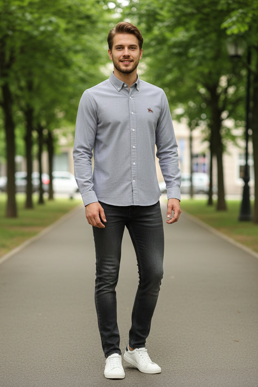 Folded gray shirt with a brand logo on a light background