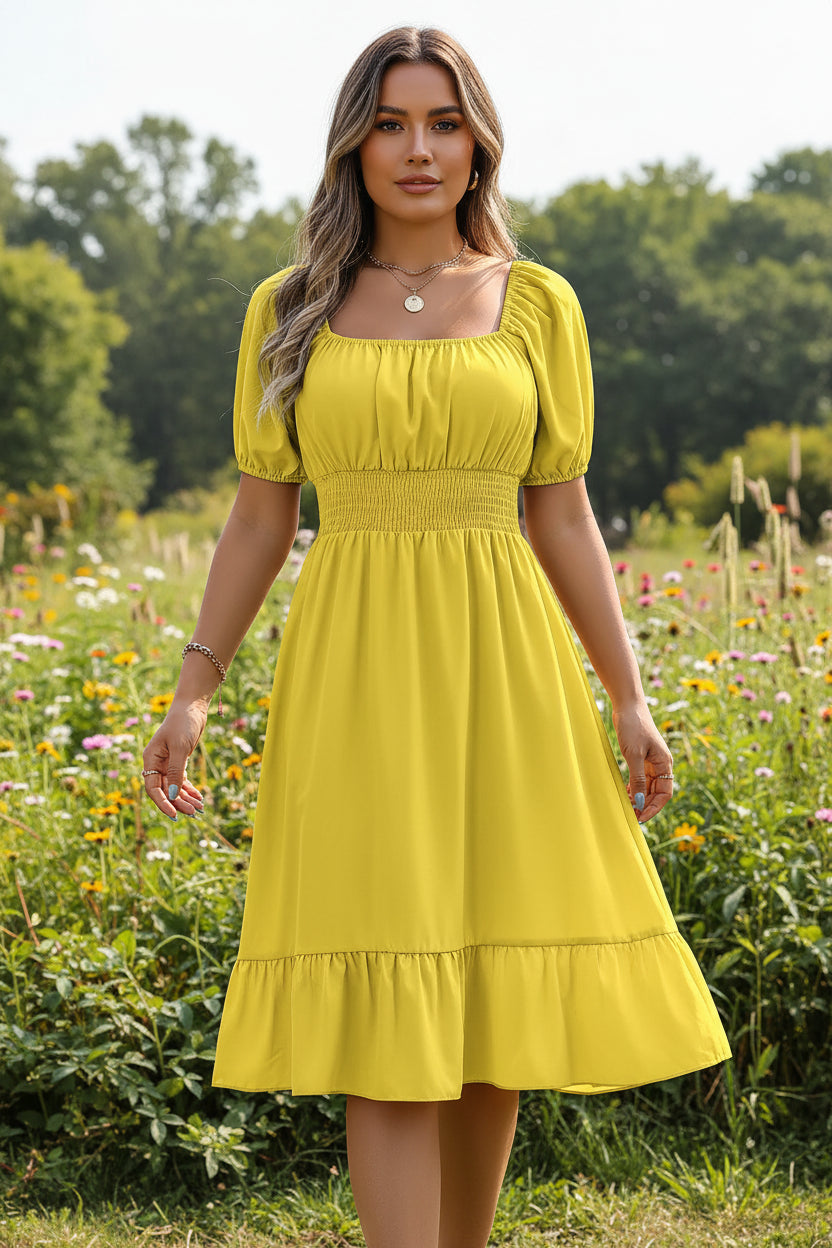 Woman wearing a yellow dress with puff sleeves in an indoor setting.