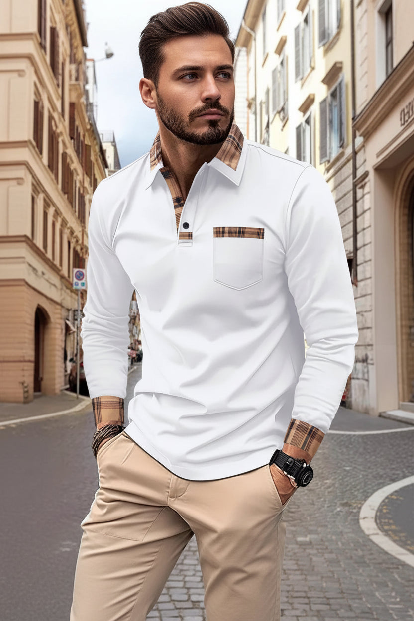 Man wearing a white long-sleeve shirt with plaid accents on a city street.