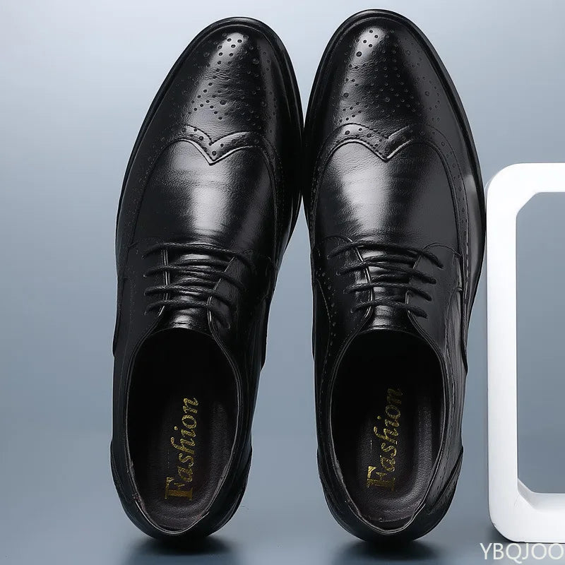 Pair of black leather dress shoes on a light gray background