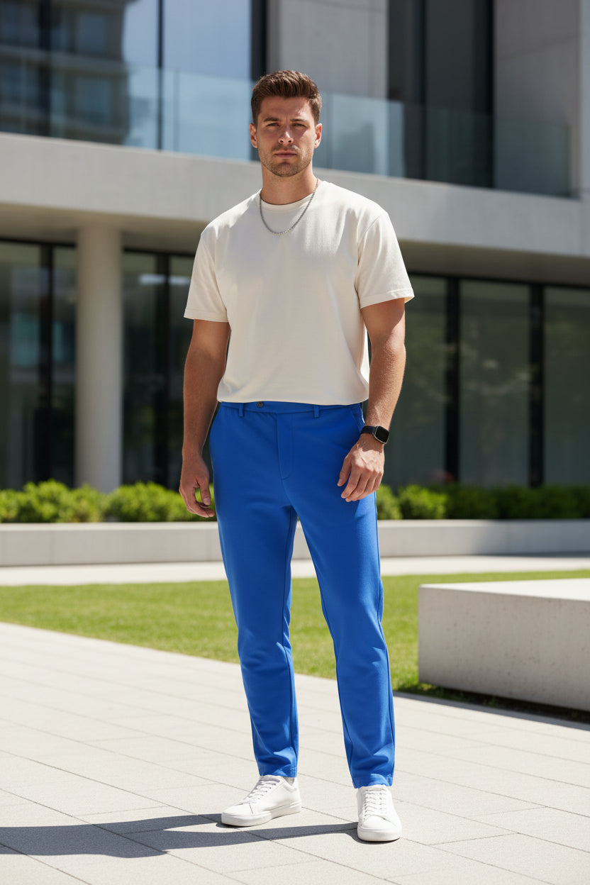 Blue athletic pants with a zipper pocket on a white background