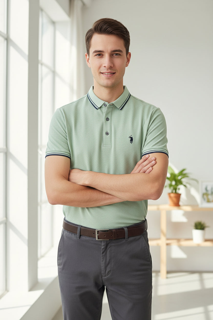 Light green polo shirt with a brand logo on a rack with other shirts in the background