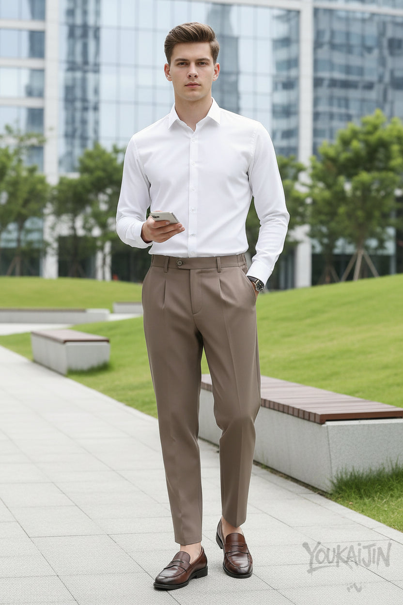 Person wearing beige pants and brown shoes in a modern indoor setting