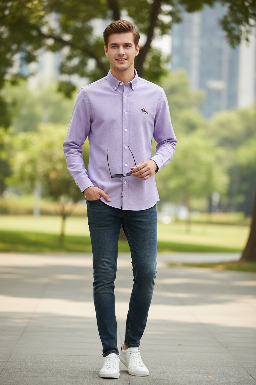 Folded purple shirt with a brand logo on a light gray background