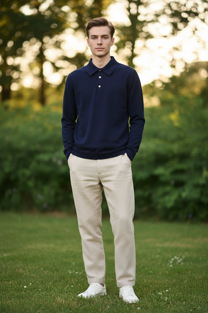 Navy blue polo shirt with gold buttons on a plain background