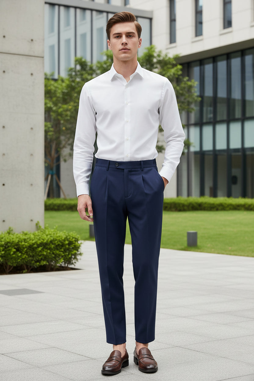 Person wearing navy pants and brown shoes in a modern indoor setting