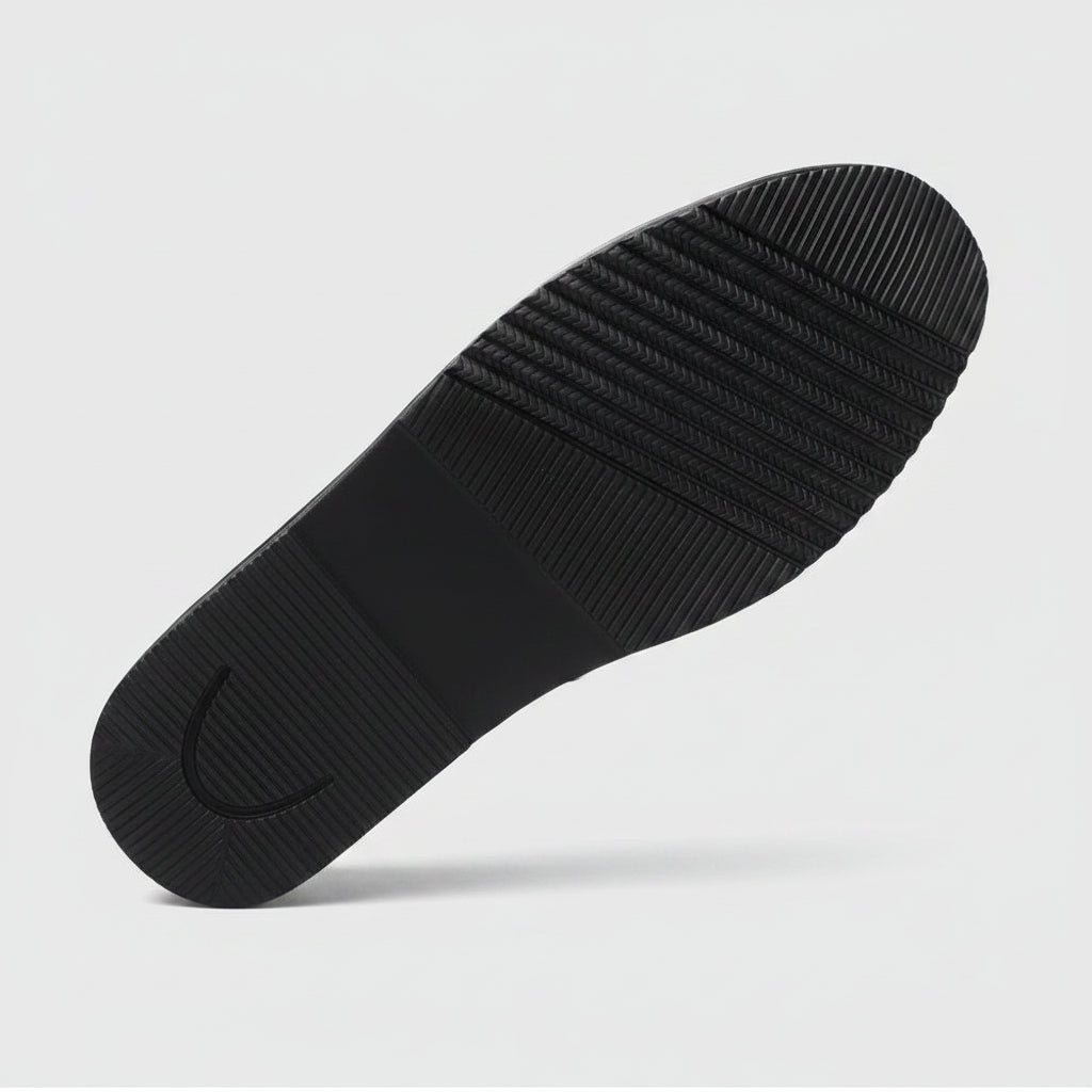 Black shoe sole with text and a red logo on a white background