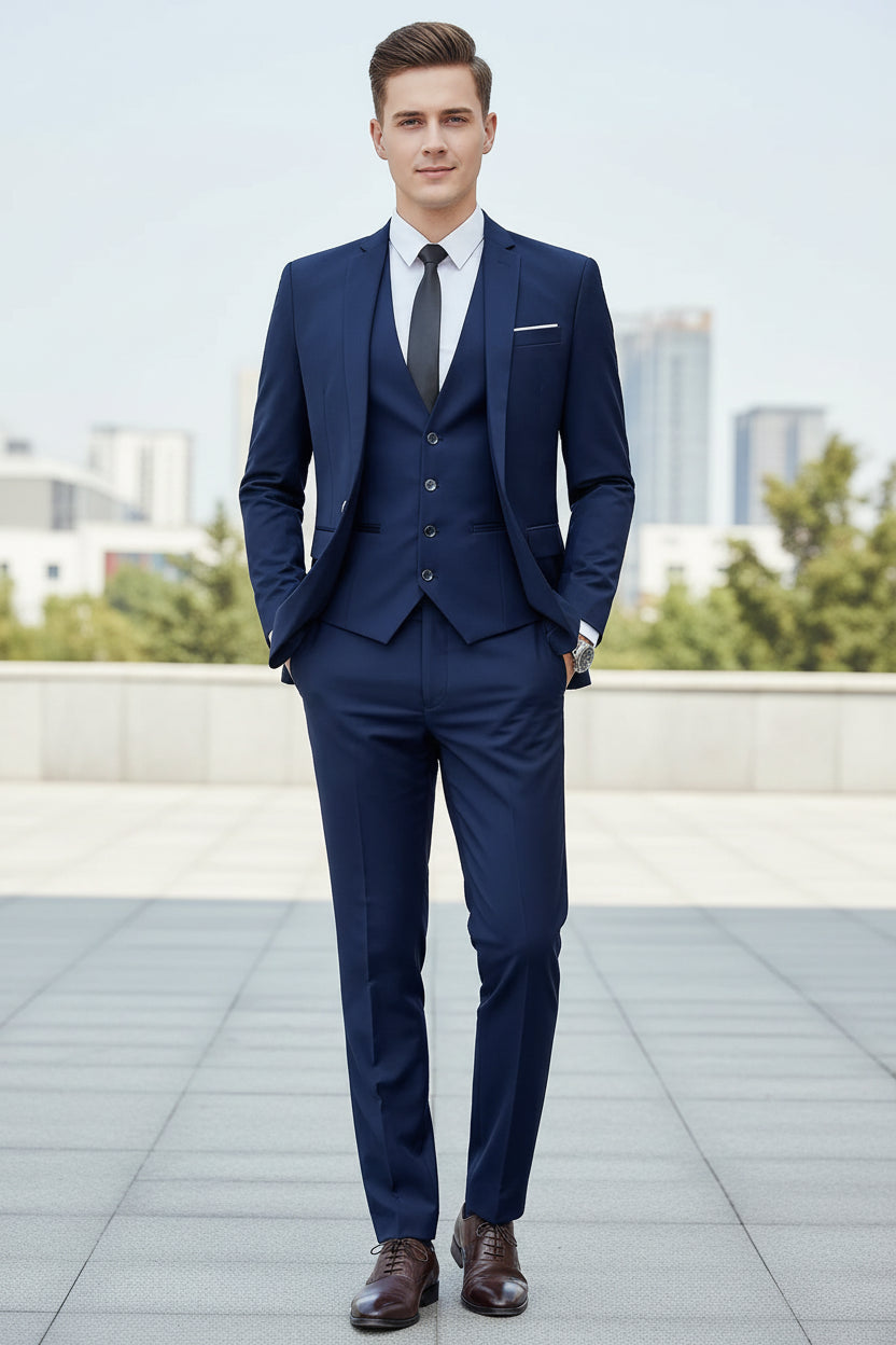 Man wearing a blue suit with a white shirt and black tie against a neutral background
