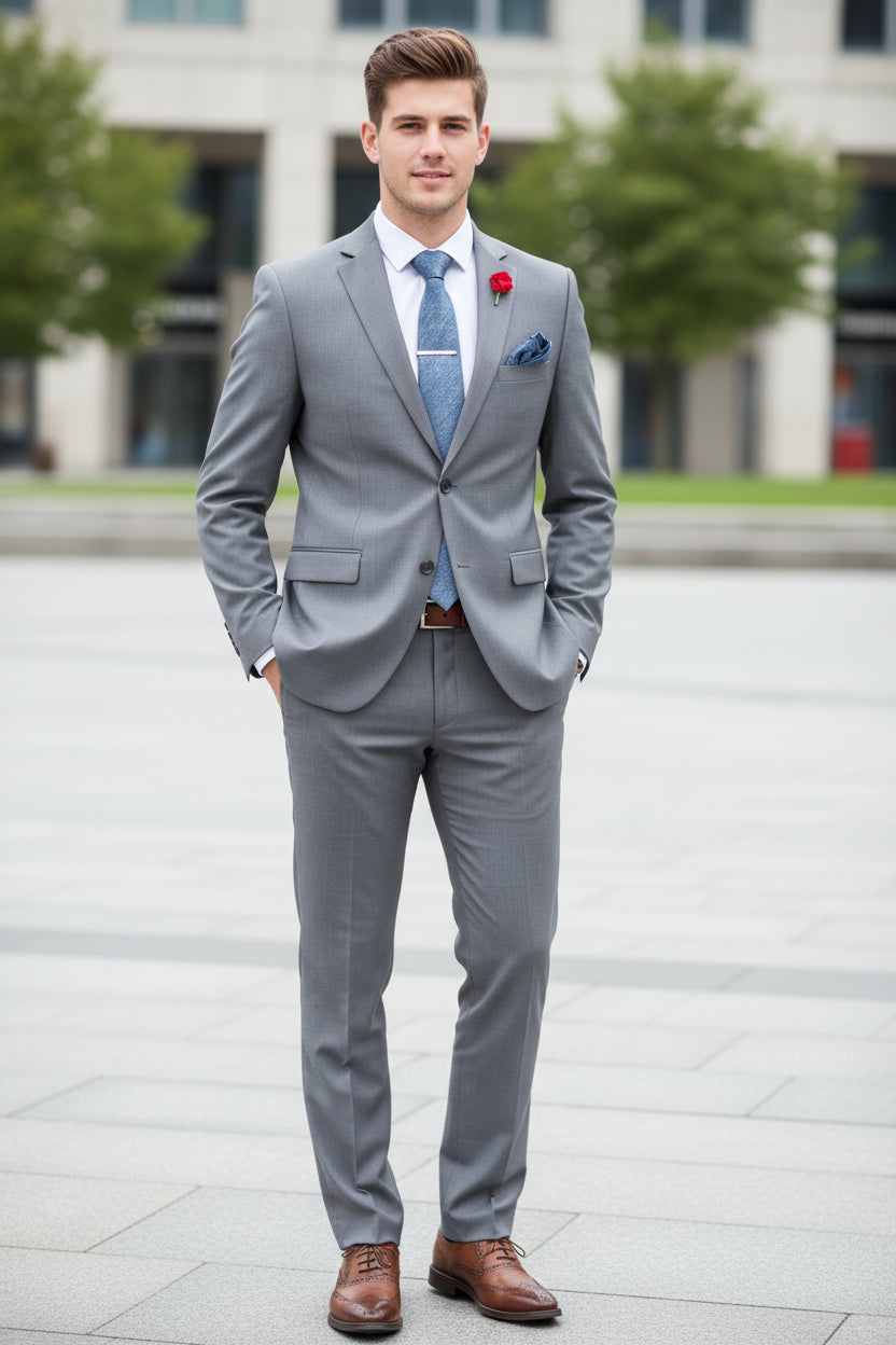 Gray suit with matching tie and shoes on a mannequin against a white background