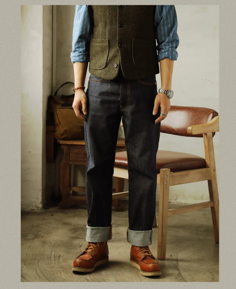 Person wearing a vest, shirt, jeans, and brown shoes in a rustic setting.