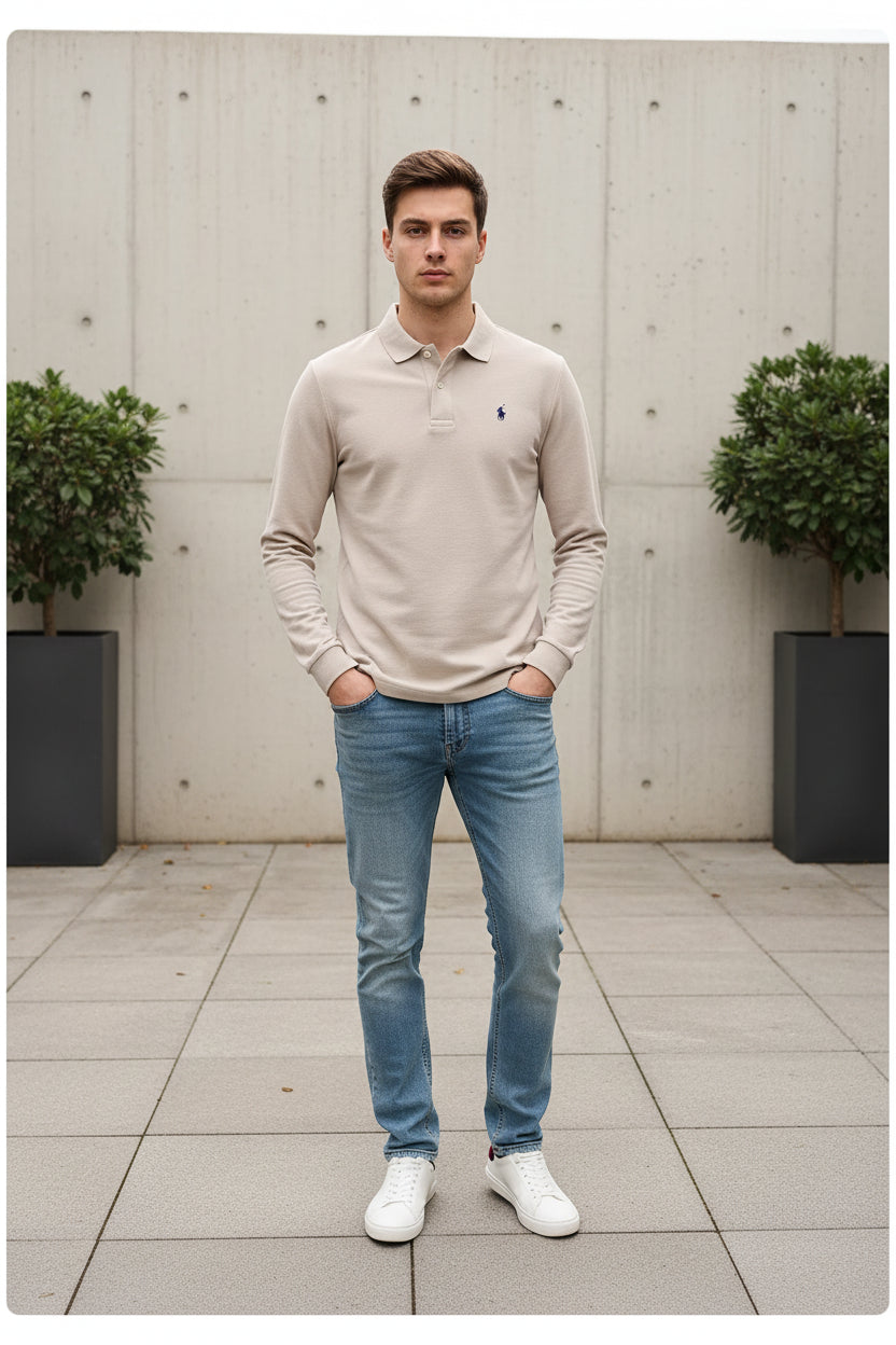 Beige long-sleeve polo shirt with a brand logo on a clothing rack.
