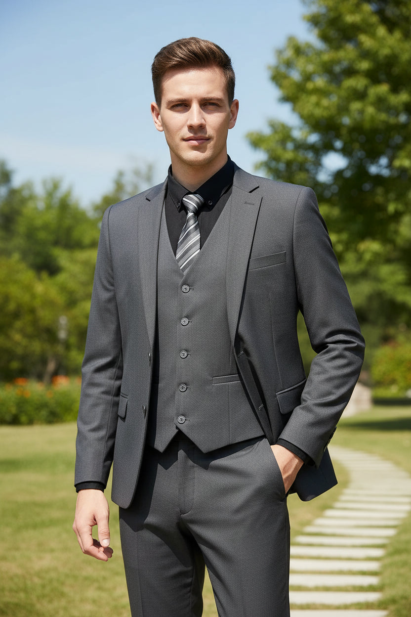 Man wearing a gray suit with a striped tie in an indoor setting