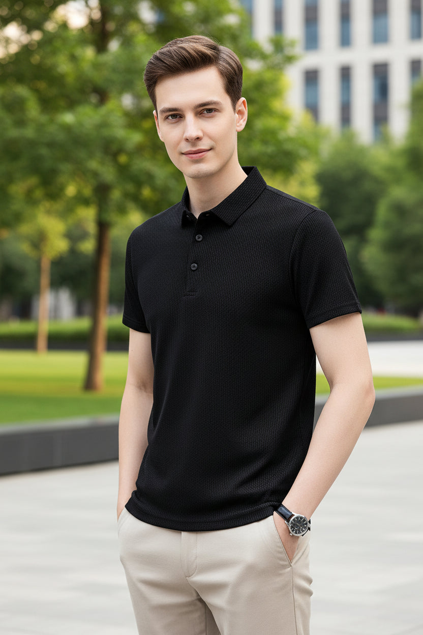 Black textured polo shirt worn by a person on a gray background