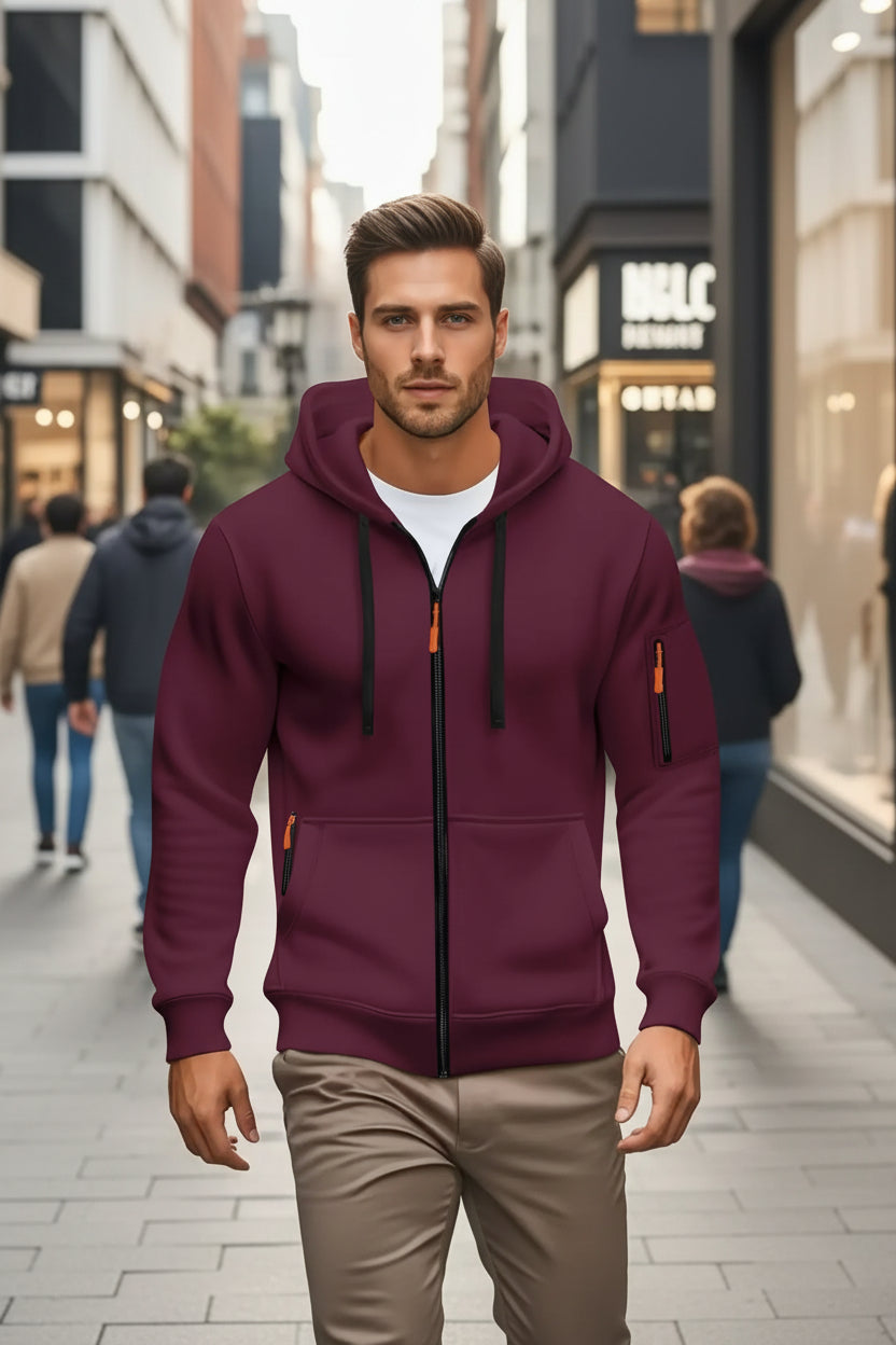 Man wearing a maroon hoodie with orange accents in an urban setting