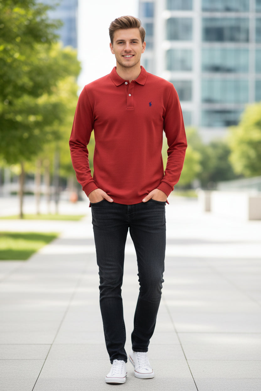 Red long-sleeve polo shirt with a brand logo on a rack with other colored shirts.