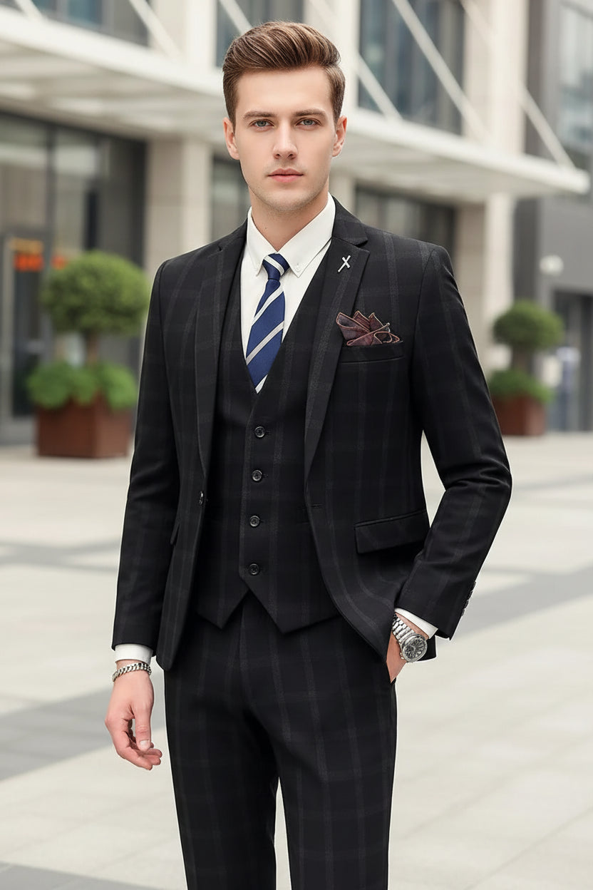 Man wearing a dark pinstripe suit with a white shirt and blue tie, standing against a marble wall.