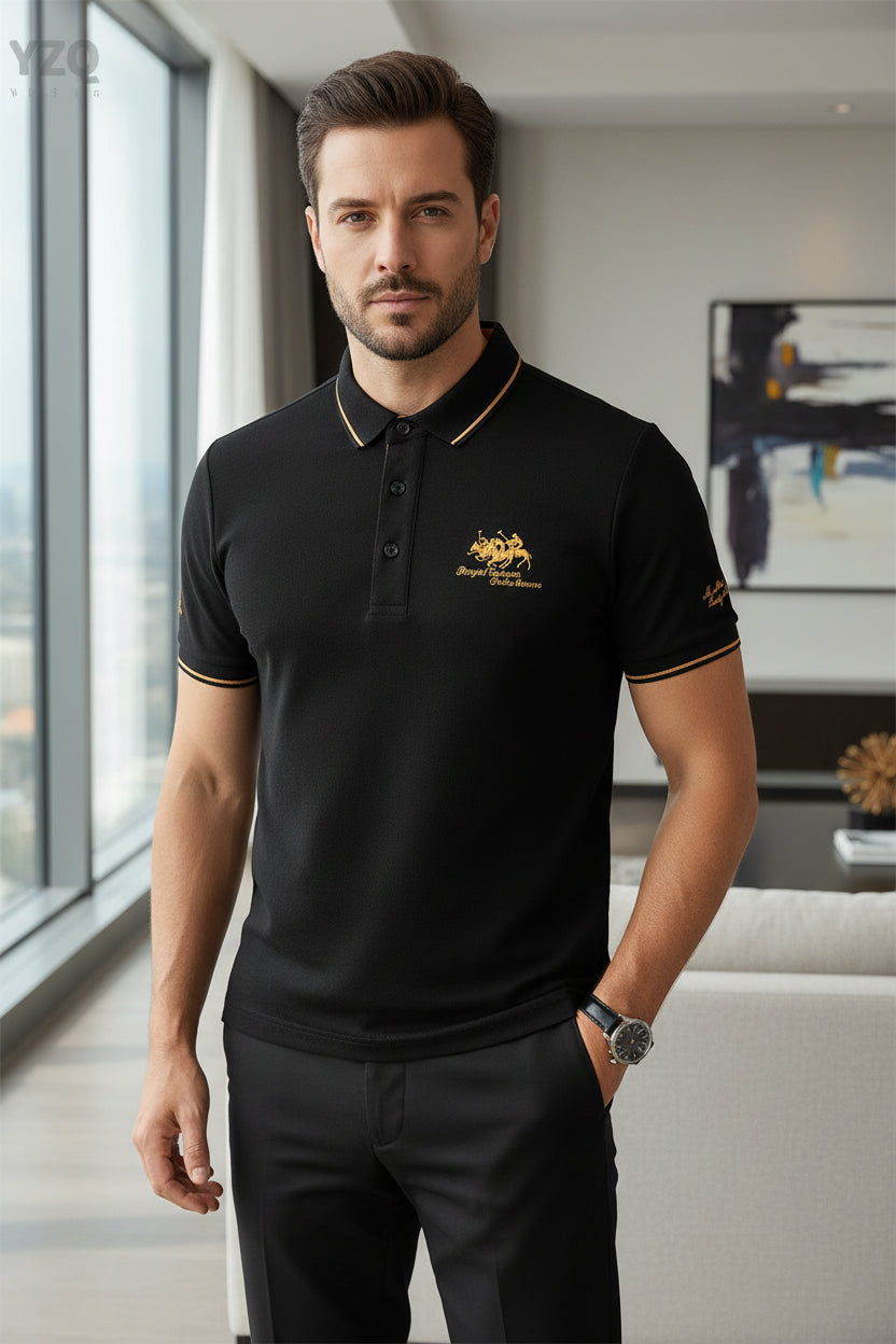 Black polo shirt with gold embroidery on a dark surface, featuring the brand 'YZQ'.