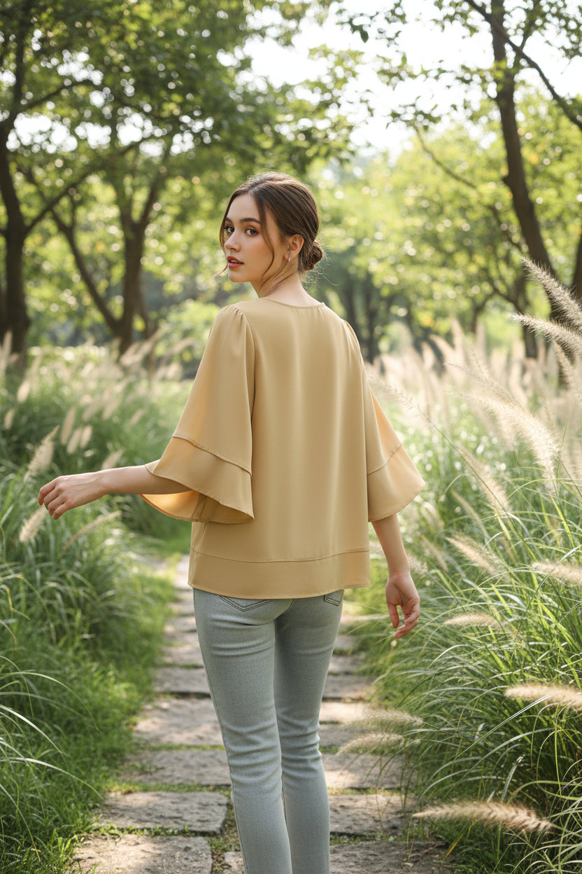 Beige blouse on a hanger  