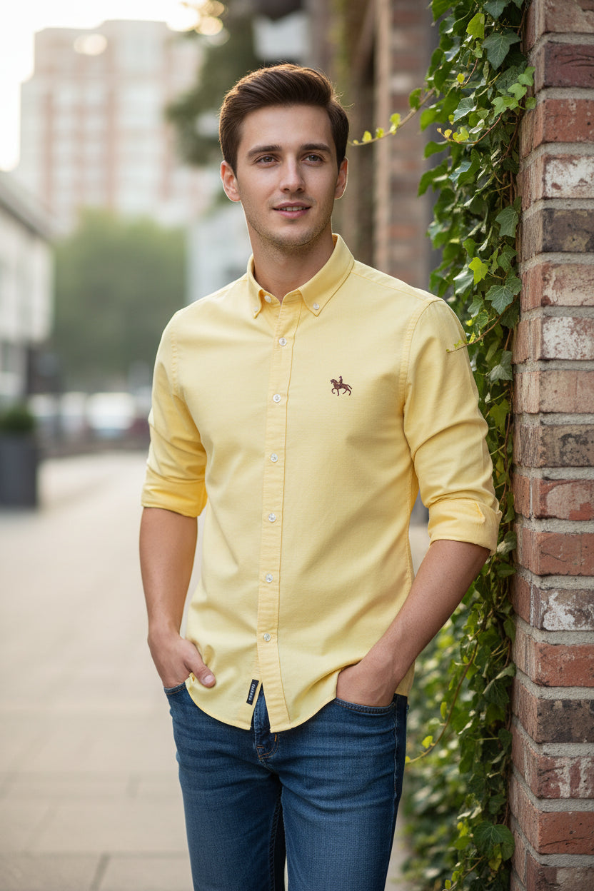Yellow shirt with a brand logo on a white background