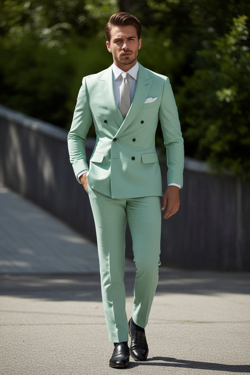 Mint green suit with a white shirt and patterned tie against a blurred background