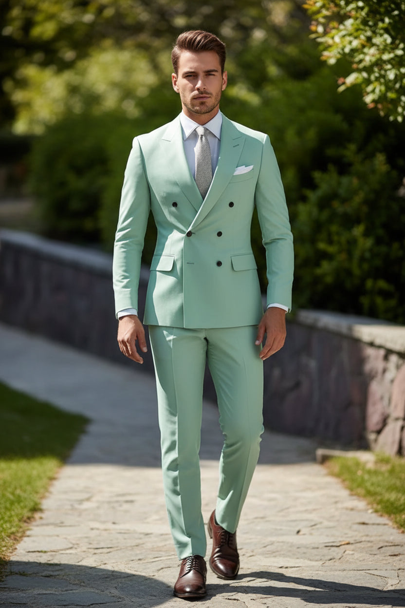 Mint green suit with a white shirt and patterned tie against a blurred background