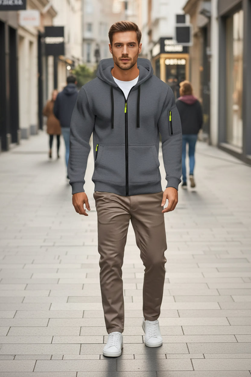Gray hoodie with orange accents worn by a person on a blurred street background