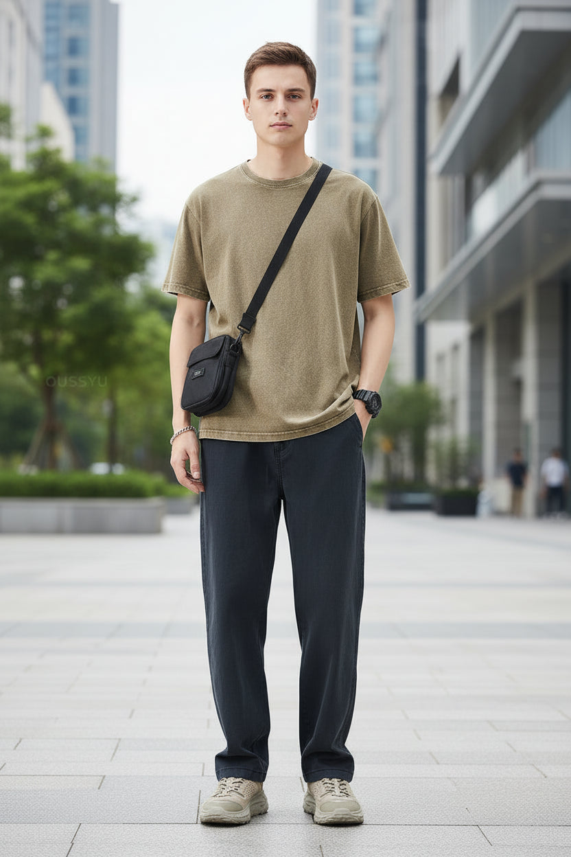 Person wearing dark blue pants with a plain white background