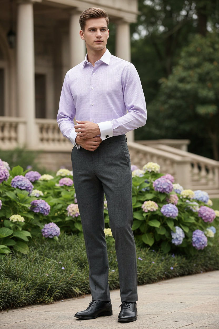 Folded light purple dress shirt with white collar and cufflinks on a white background