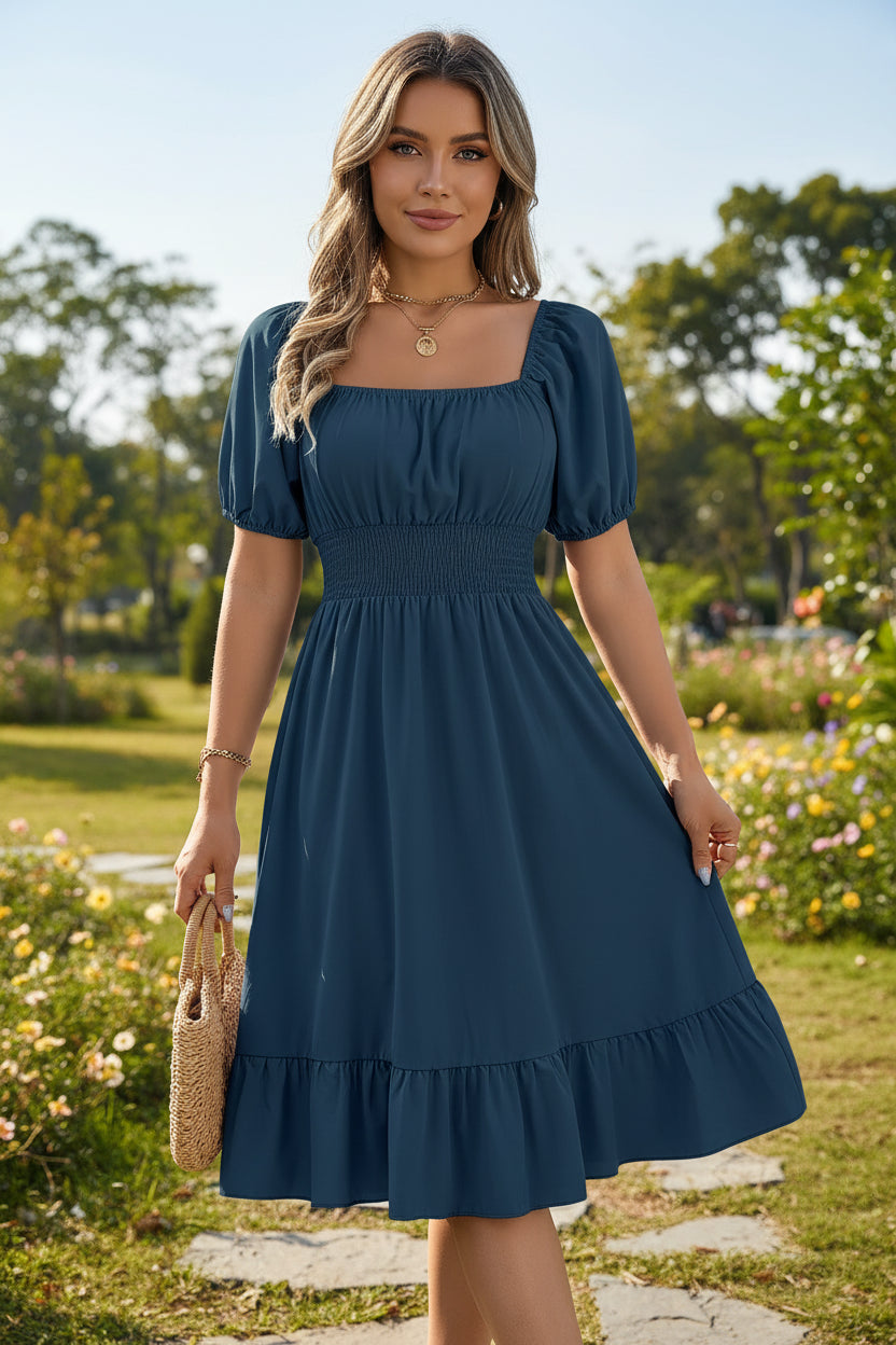Woman wearing a blue dress with puff sleeves in a home setting.